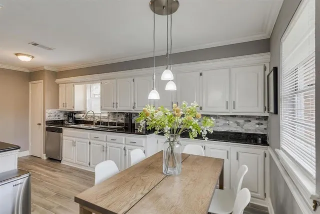 a kitchen with stainless steel appliances kitchen island granite countertop a stove a sink and a white refrigerator