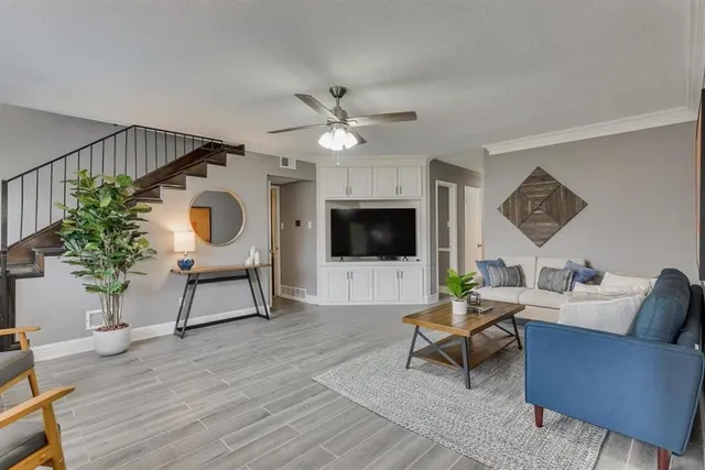 a living room with furniture a flat screen tv and a fireplace