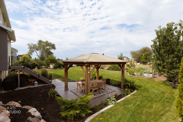 1654 South 730 West Provo, UT 84601 - Photo 29 of 33 Spacious backyard featuring a wood-frame gazebo with a metal roof, concrete patio, expansive lawn, and mature landscaping