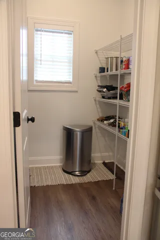 a bedroom with a bed window and a table