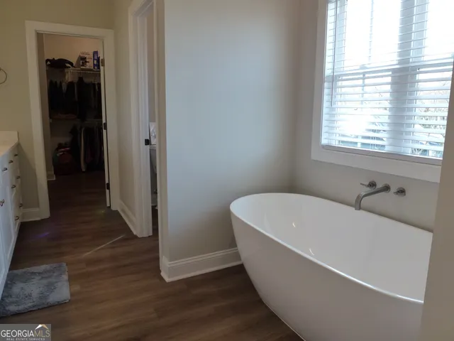 a bed sitting in a bedroom next to a window