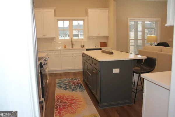 a kitchen with a sink a table and chairs