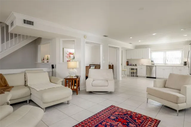 a living room with furniture and view of kitchen