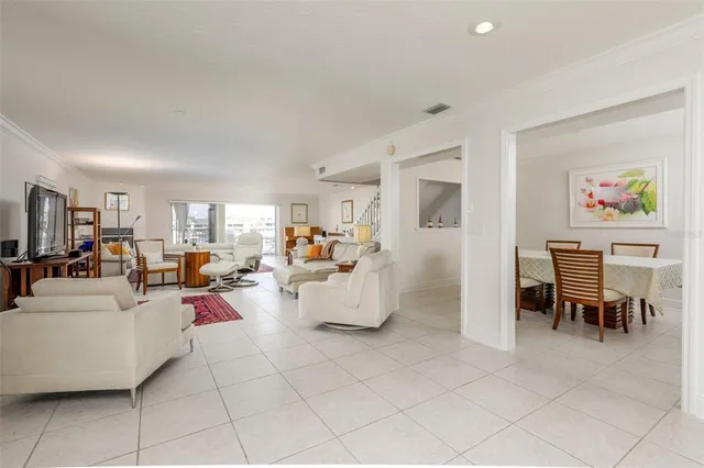 a living room with furniture and a dining table