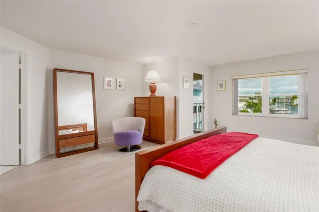 a bedroom with a bed and dresser with mirror