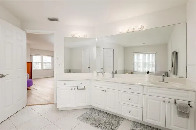 a spacious bathroom with a granite countertop sink mirror and