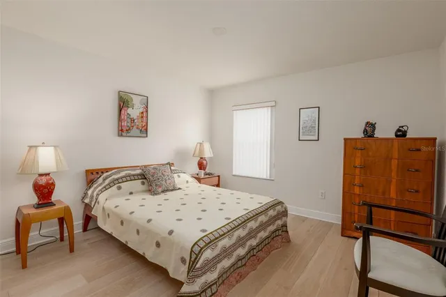 a bedroom with a bed and dresser