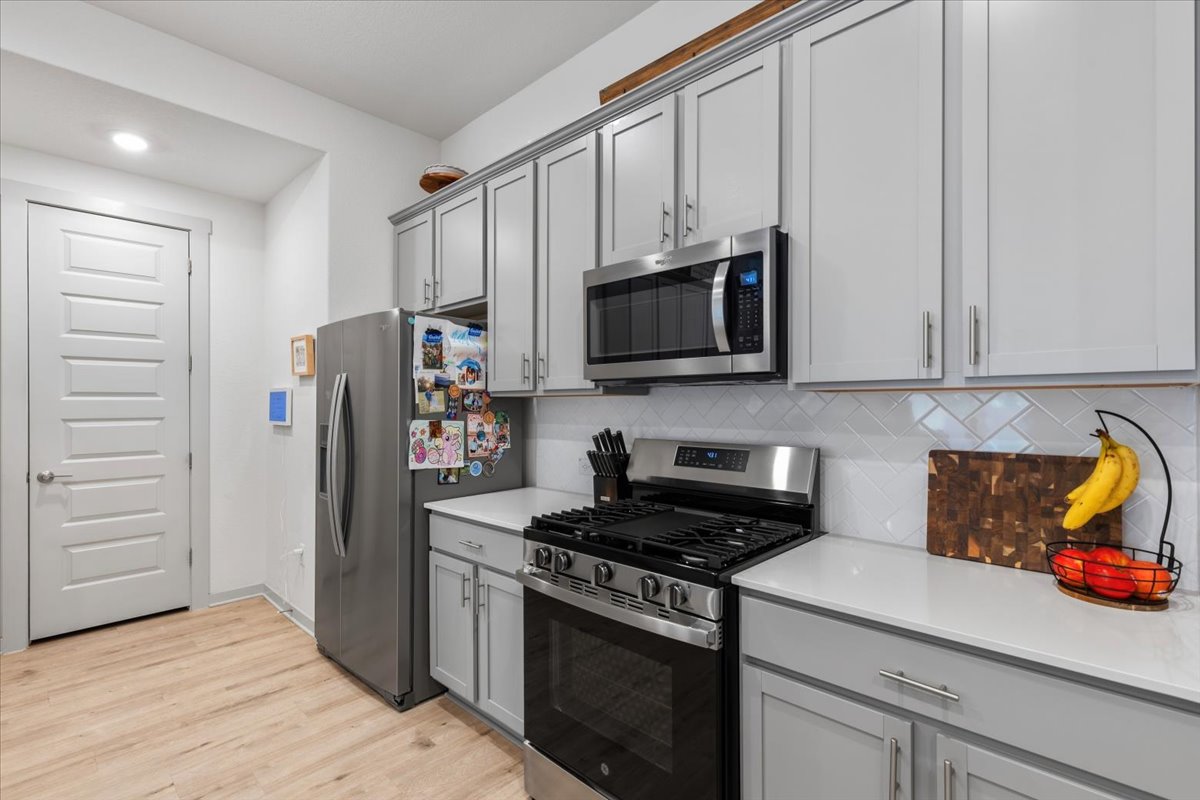 2117 Centerline Lane Georgetown, TX 78628 - Photo 12 of 31 a kitchen with stainless steel appliances granite countertop a refrigerator stove and microwave