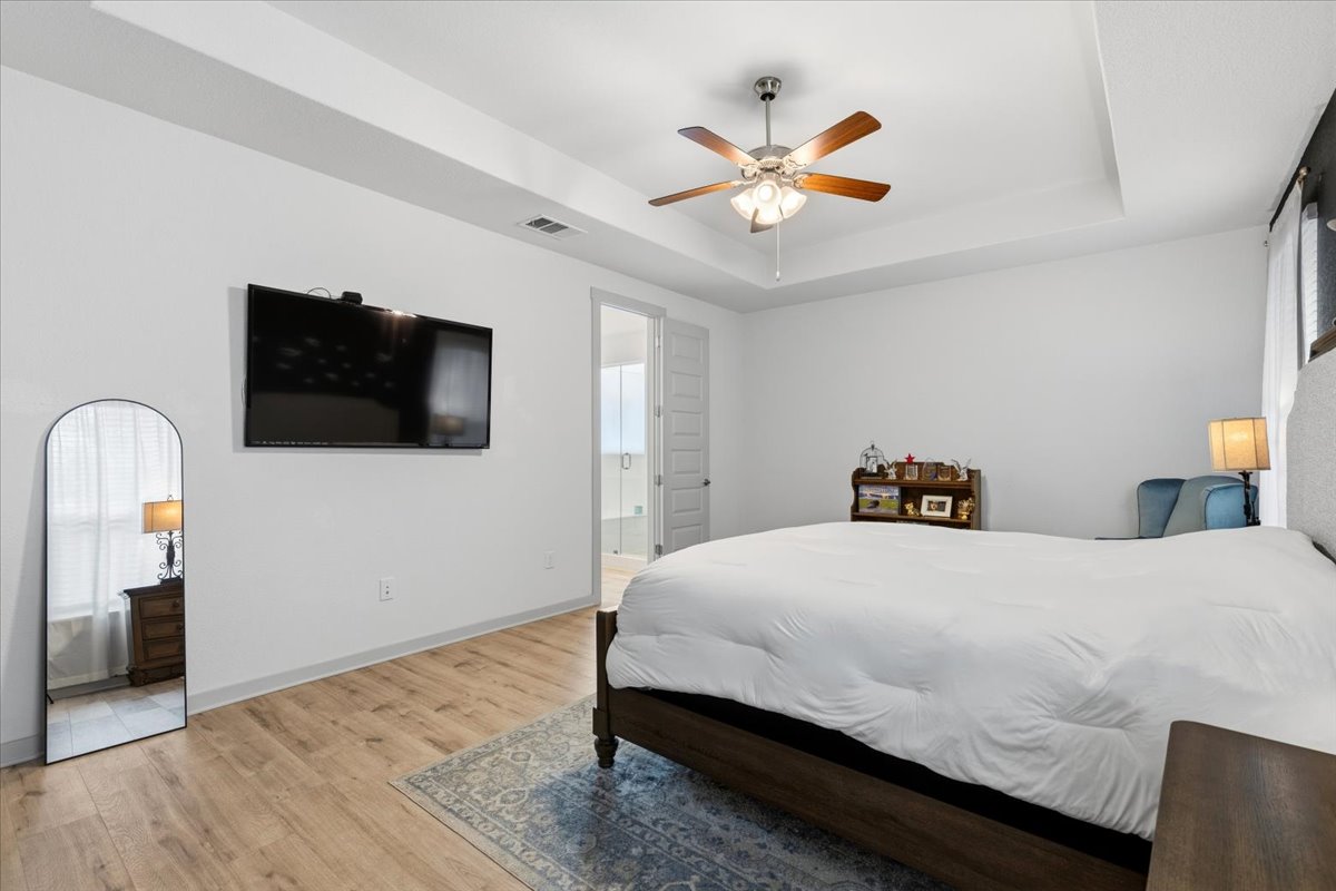 2117 Centerline Lane Georgetown, TX 78628 - Photo 17 of 31 a bedroom with a bed and a flat screen tv
