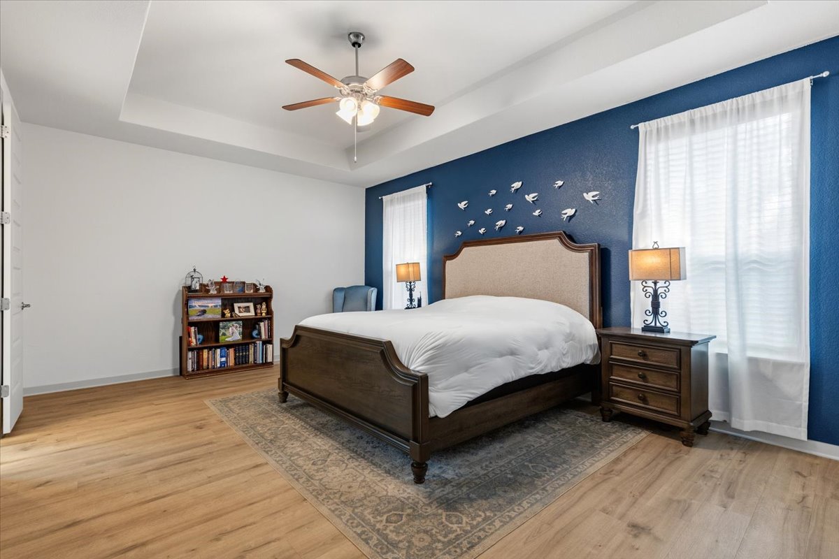2117 Centerline Lane Georgetown, TX 78628 - Photo 18 of 31 a bedroom with a large bed and a chandelier