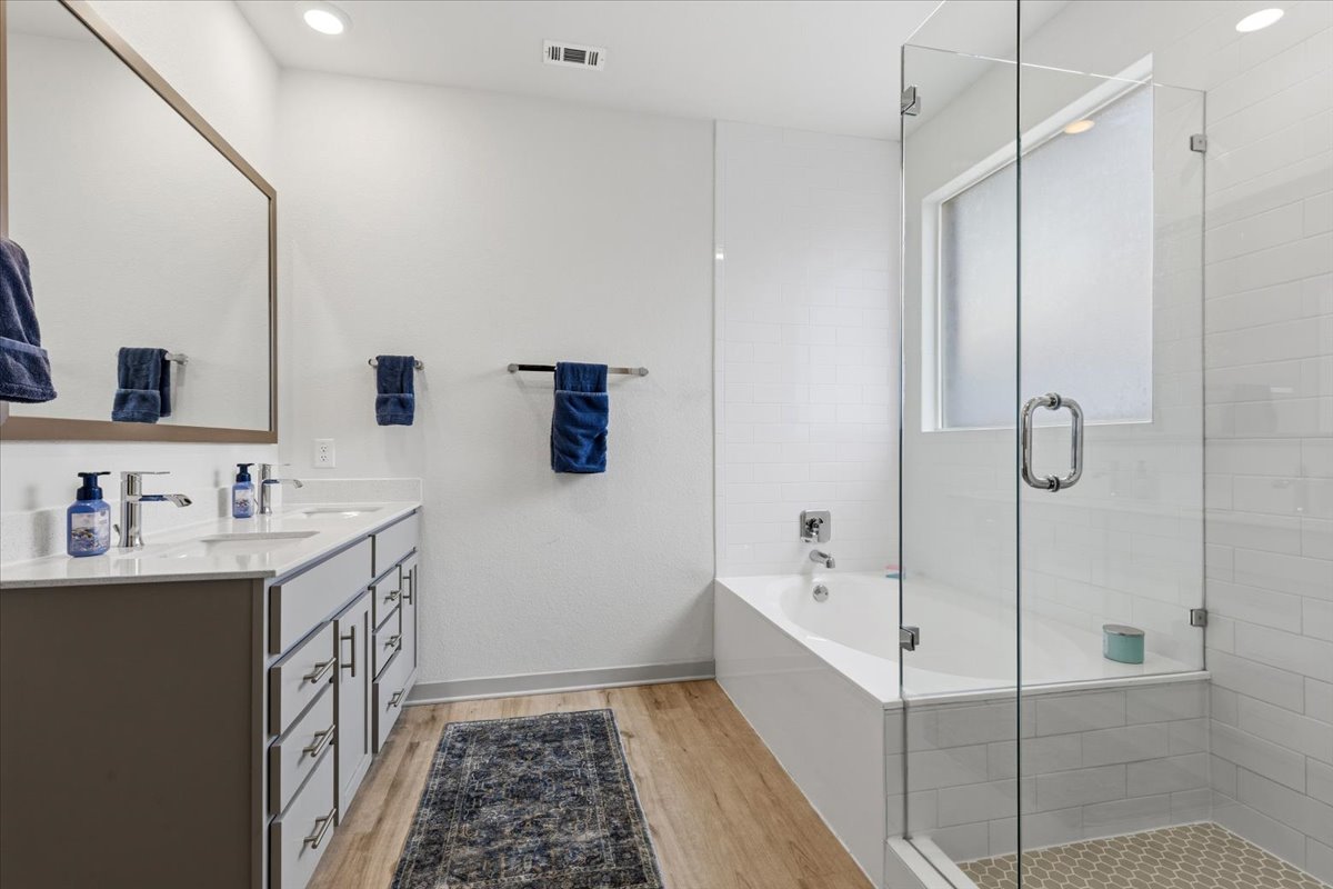2117 Centerline Lane Georgetown, TX 78628 - Photo 20 of 31 a bathroom with a double vanity sink a mirror and a shower