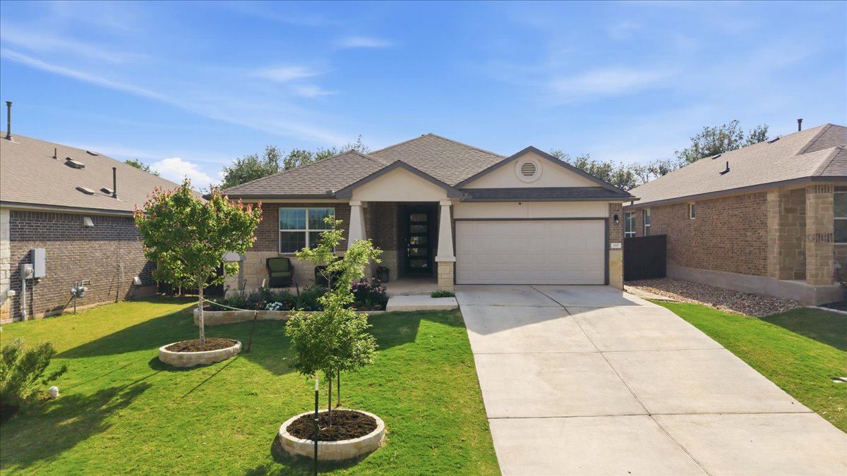 2117 Centerline Lane Georgetown, TX 78628 - Photo 2 of 31 a front view of a house with a yard and garage