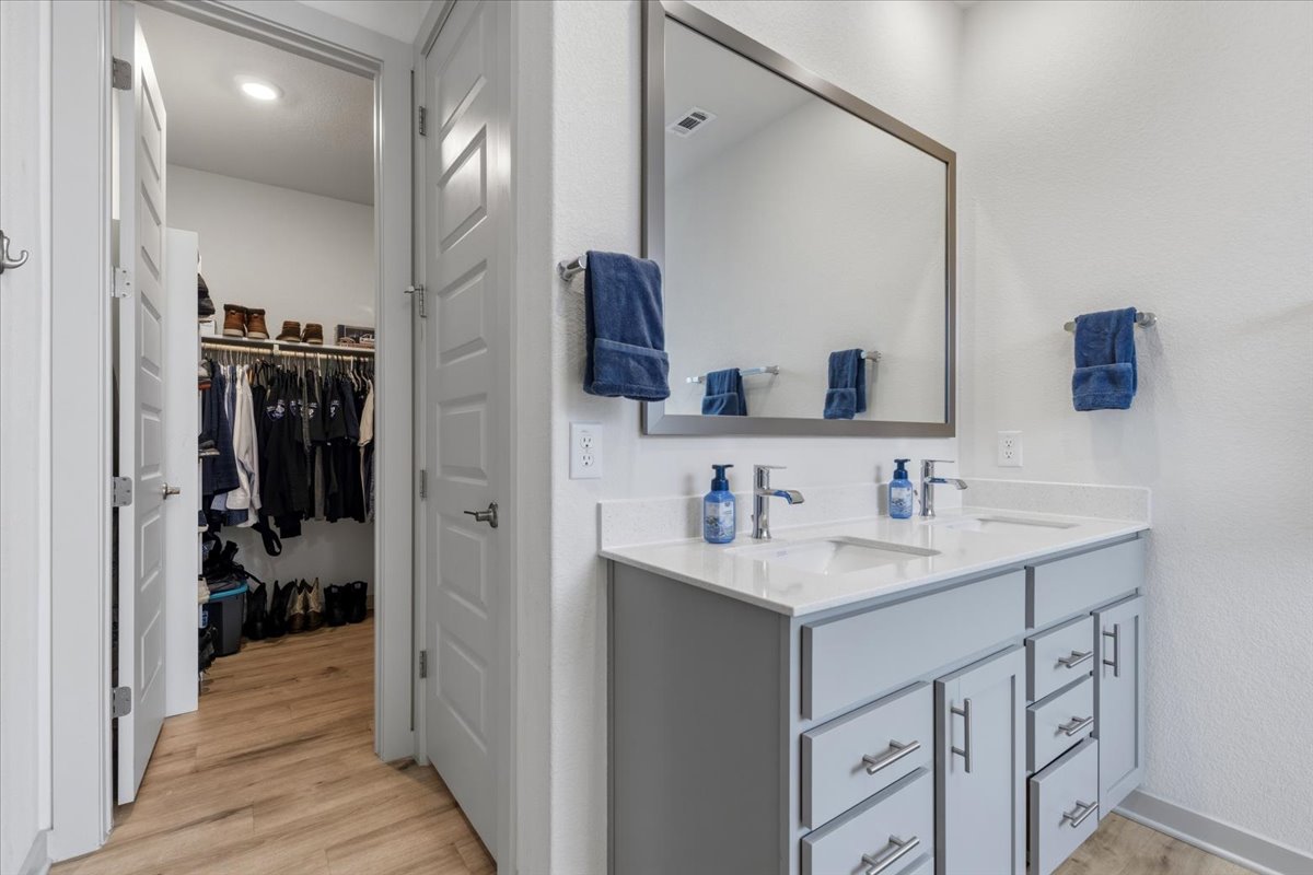 2117 Centerline Lane Georgetown, TX 78628 - Photo 22 of 31 a en suite bathroom with a sink a mirror and shower