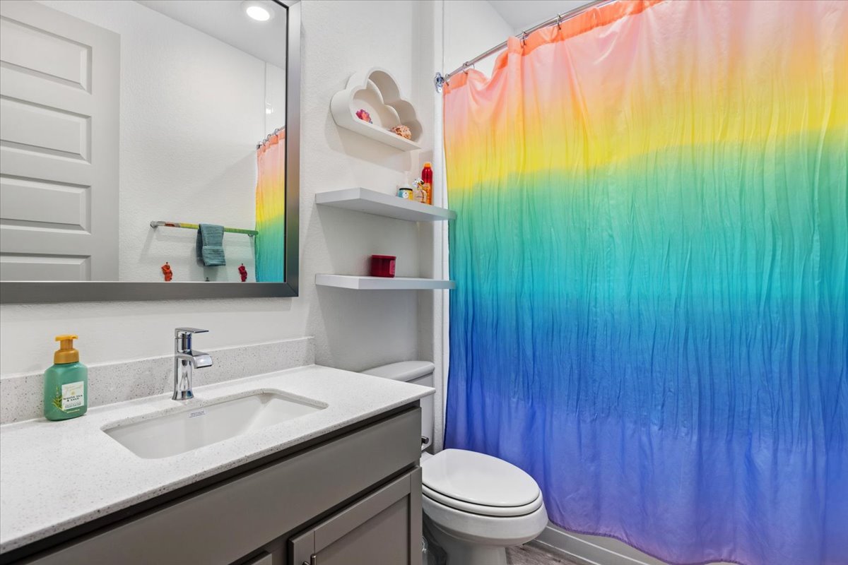 2117 Centerline Lane Georgetown, TX 78628 - Photo 24 of 31 a bathroom with a sink a toilet and a mirror