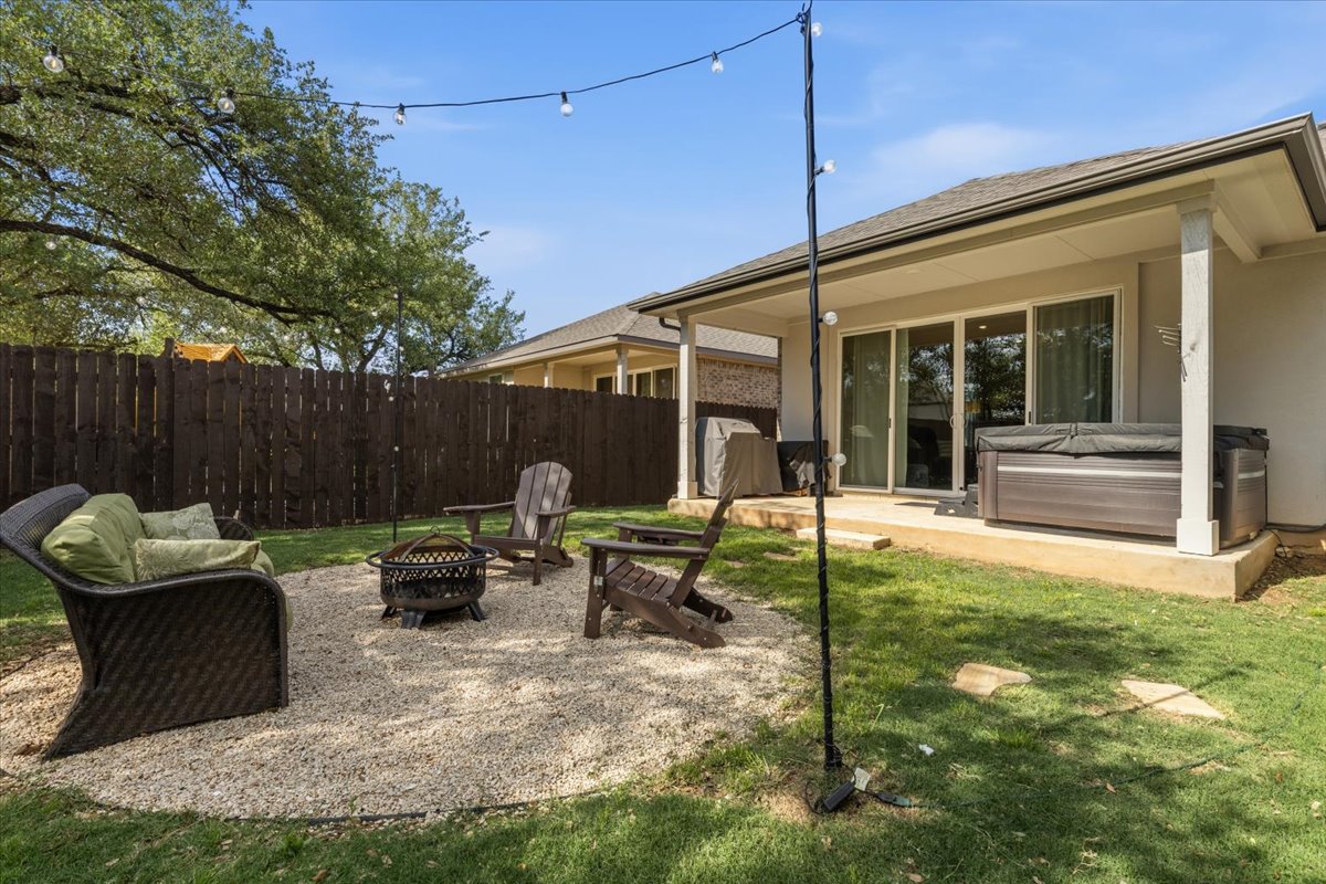 2117 Centerline Lane Georgetown, TX 78628 - Photo 27 of 31 a backyard of a house with yard table and chairs