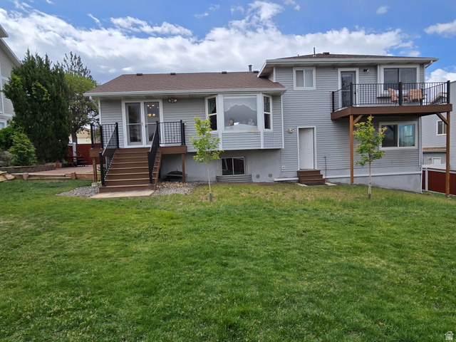 1263 Grayson Court Sandy, UT 84094 - Photo 24 of 26 Expansive rear yard featuring a large green lawn