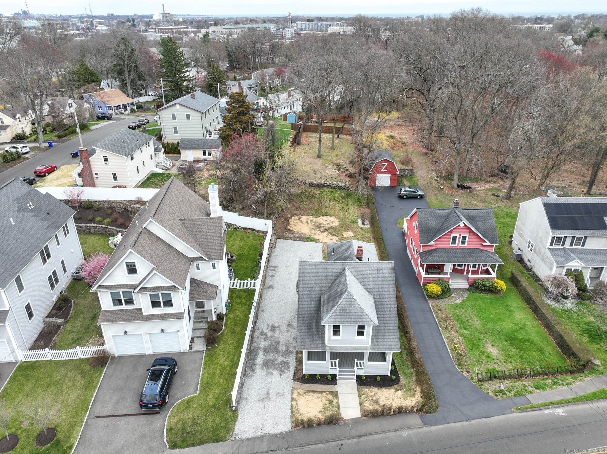 an aerial view of residential houses with outdoor space and parking