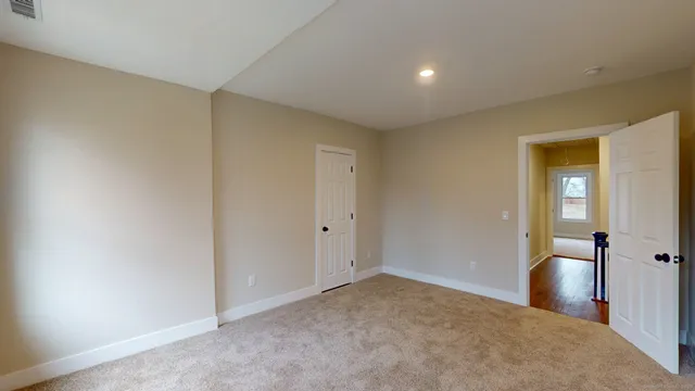 an empty room with windows and closet