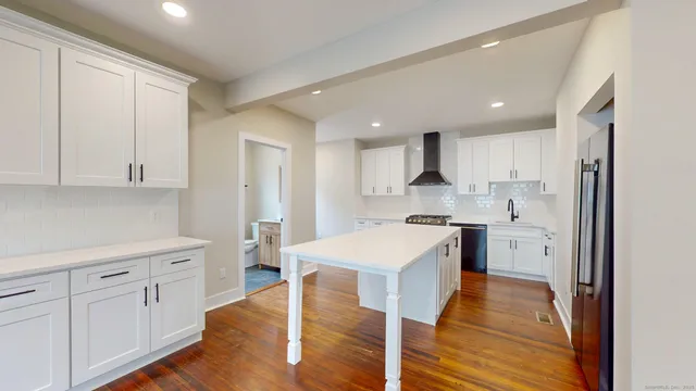 a kitchen with white cabinets and white appliances