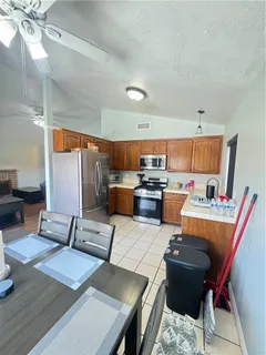 a living room with stainless steel appliances kitchen island granite countertop furniture and a view of kitchen