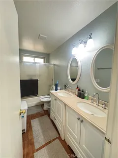 a bathroom with a toilet a sink and a mirror