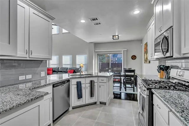 a kitchen with lots of counter top space appliances and cabinets