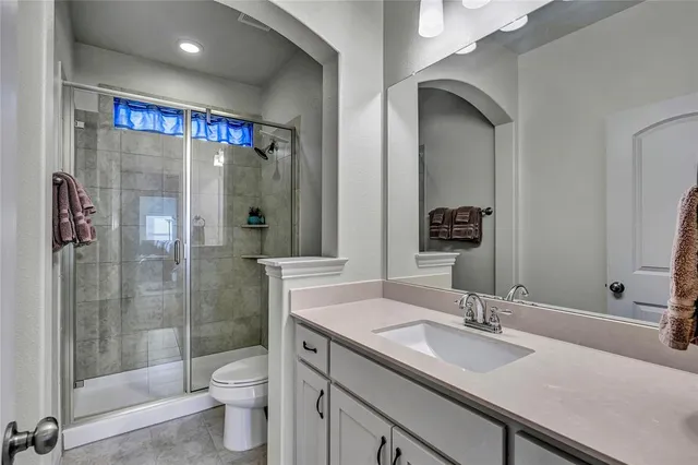 a bathroom with a double vanity sink toilet and shower