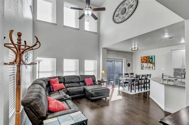 a living room with furniture a rug and a chandelier