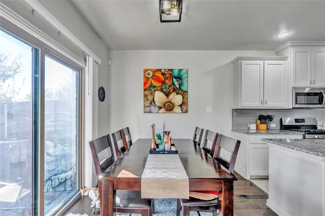 a view of a dining room with furniture a chandelier and wooden floor