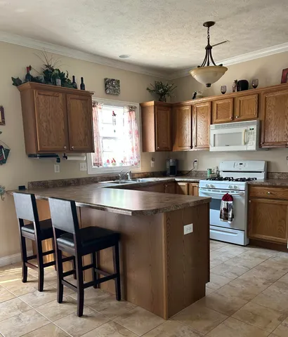 a kitchen with granite countertop a sink counter top space and cabinets