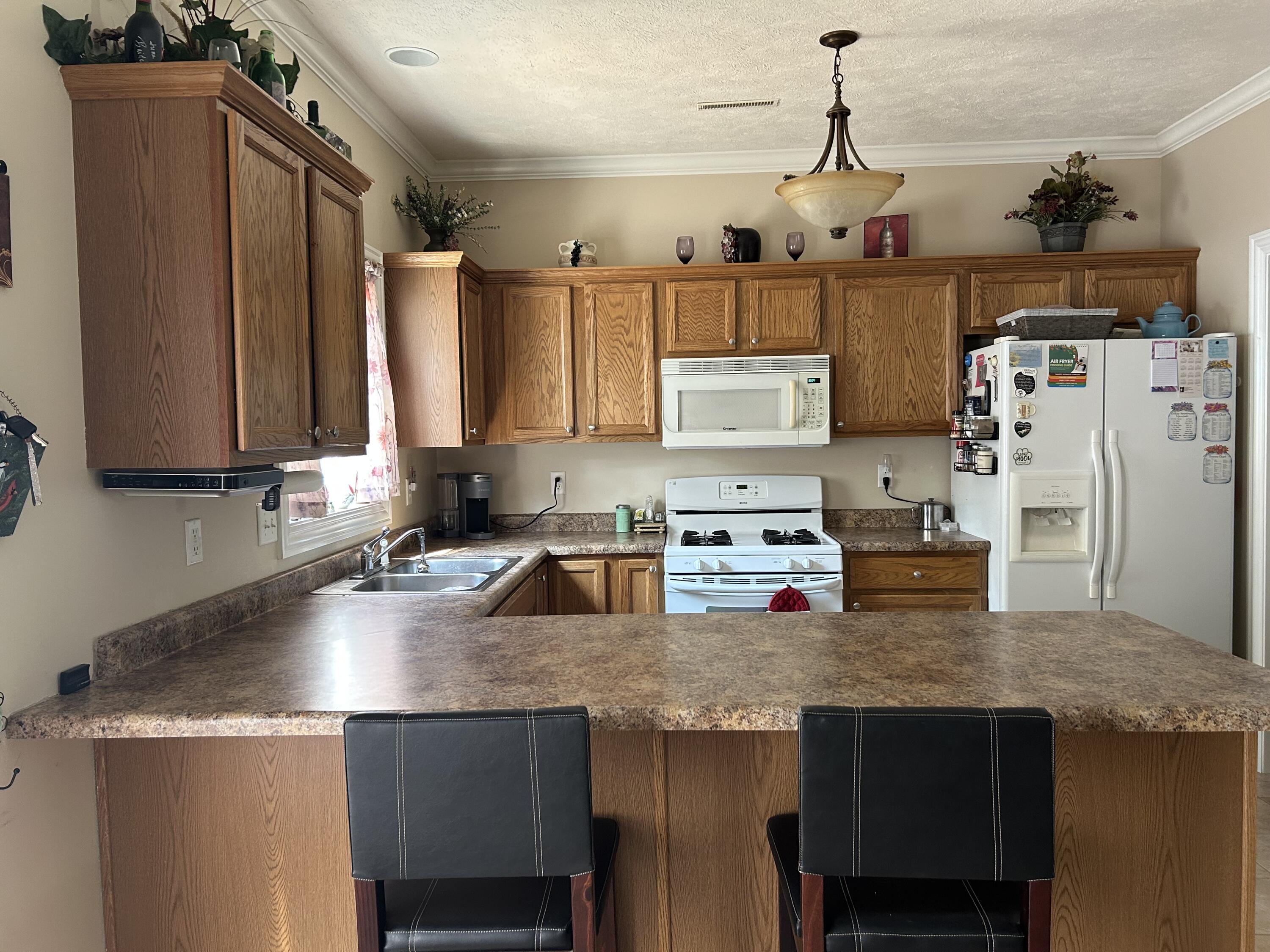 6029 Lexington Avenue Portage, IN 46368 - Photo 6 of 24 a kitchen with stainless steel appliances granite countertop a sink stove and refrigerator