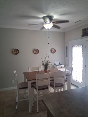 a view of a dining room with furniture and chandelier