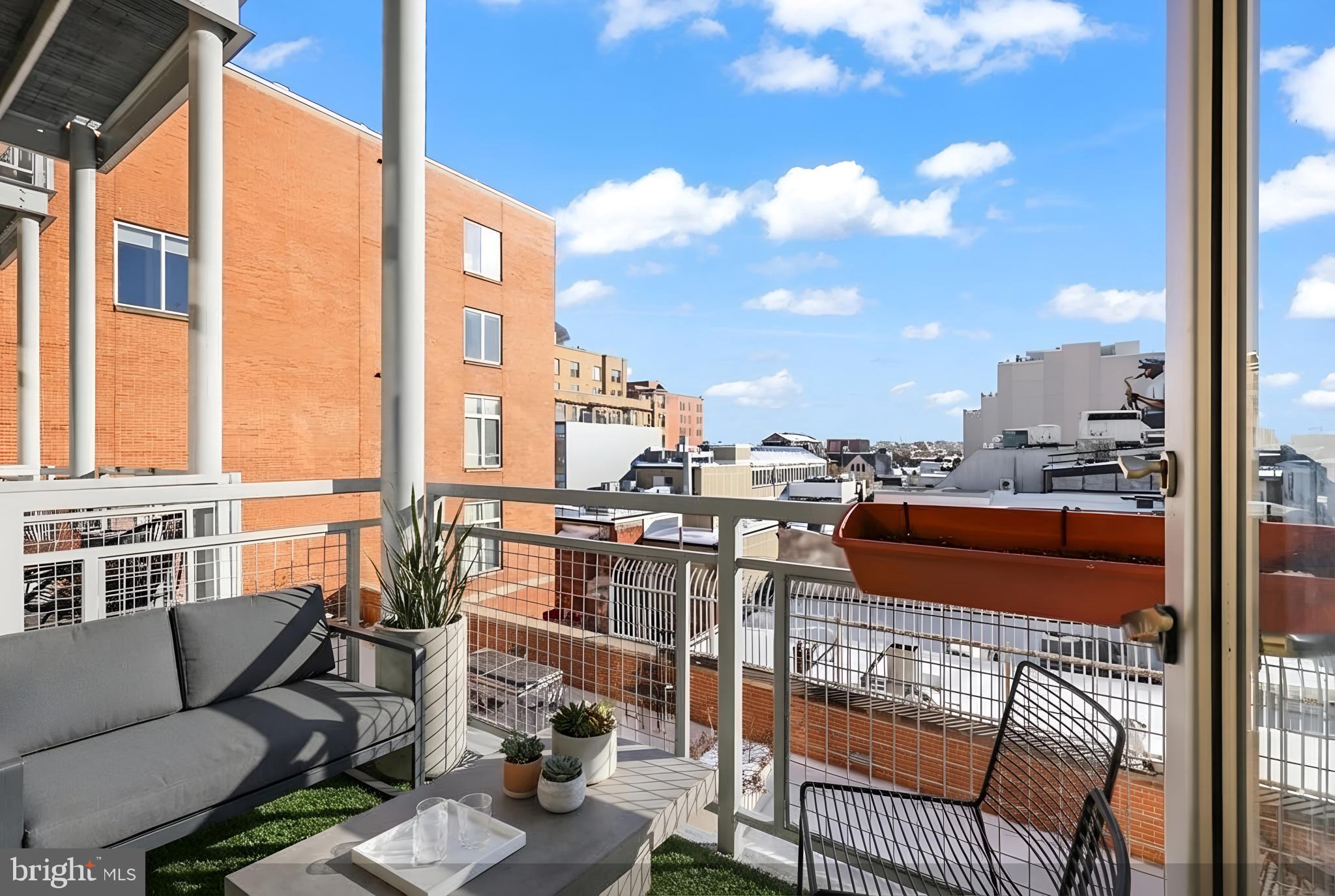 1390 V Street Northwest, Unit 307 Washington, DC 20009 - Photo 22 of 34 a city view from a balcony with furniture