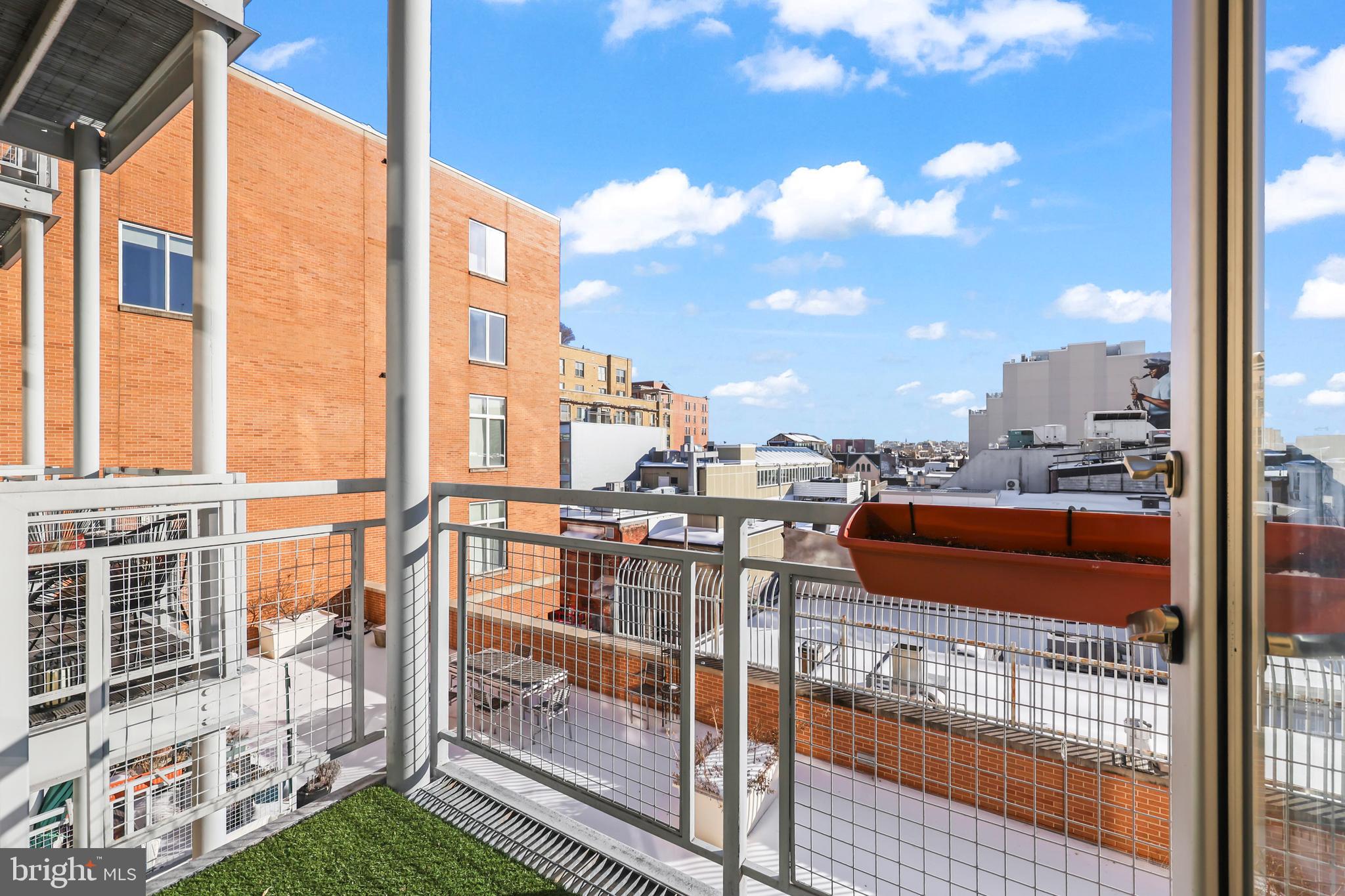 1390 V Street Northwest, Unit 307 Washington, DC 20009 - Photo 23 of 34 a city view from a balcony with wooden floor