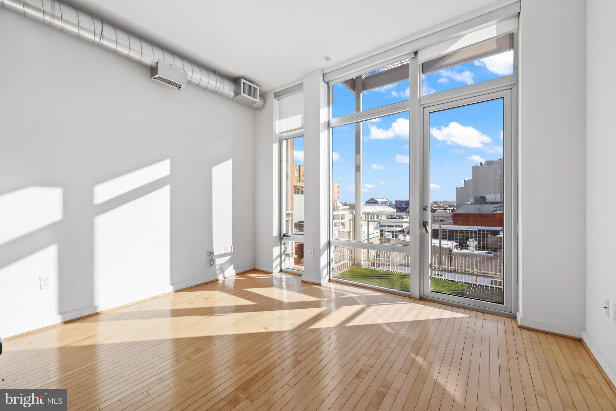 1390 V Street Northwest, Unit 307 Washington, DC 20009 - Photo 4 of 34 a view of a room with wooden floor and windows