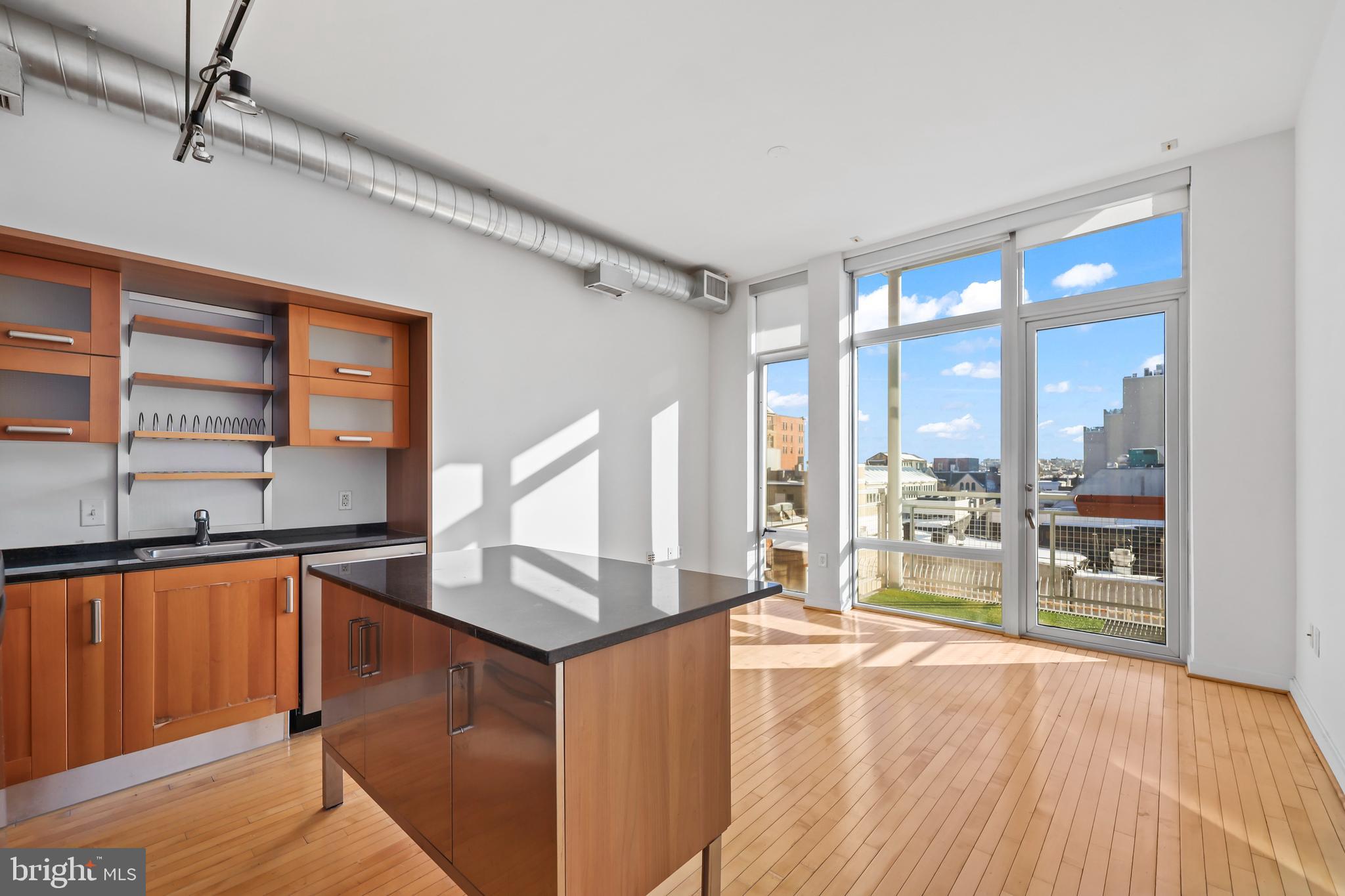 1390 V Street Northwest, Unit 307 Washington, DC 20009 - Photo 5 of 34 a kitchen with stainless steel appliances granite countertop a stove and a wooden floors