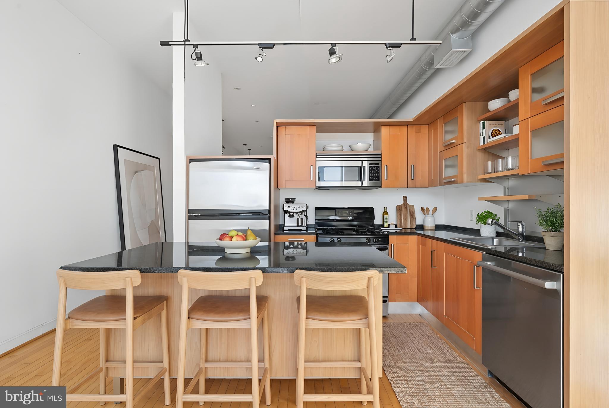 1390 V Street Northwest, Unit 307 Washington, DC 20009 - Photo 8 of 34 a kitchen with stainless steel appliances granite countertop a sink and cabinets