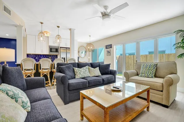 a living room with furniture a large window and a fireplace