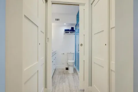 a bathroom with a granite countertop sink a toilet and a mirror