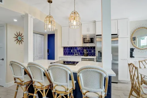 a view of a dining room with furniture a chandelier and wooden floor