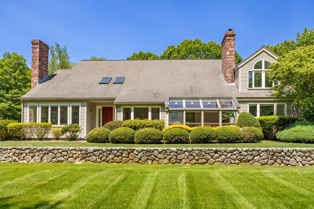 a front view of a house with a garden