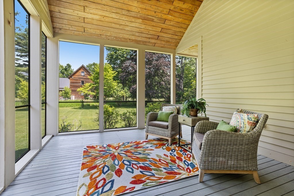 11 Farrar Road Lincoln, MA 01773 - Photo 17 of 37 a balcony view with a couch and wooden floor