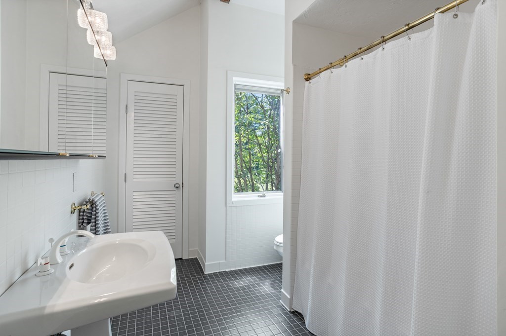 11 Farrar Road Lincoln, MA 01773 - Photo 31 of 37 a bathroom with a sink a mirror and a shower