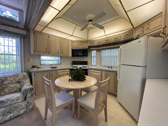 2795 East 28th Road Marseilles, IL 61341 - Photo 10 of 59 a kitchen with stainless steel appliances granite countertop a dining table and chairs