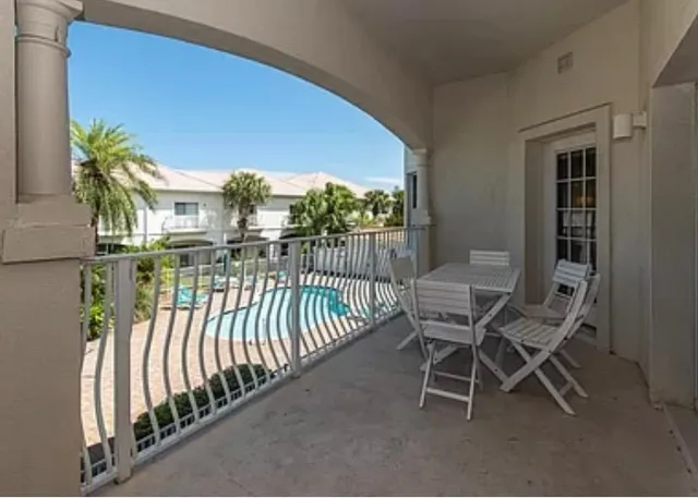 a view of a chairs and table in the balcony