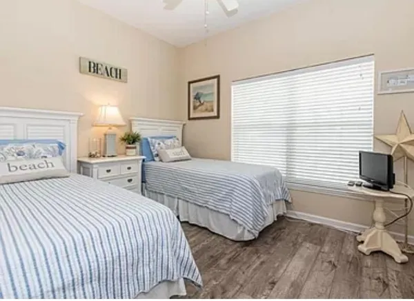 a bedroom with two beds and a window