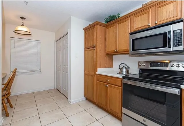 a kitchen with stainless steel appliances granite countertop a stove microwave and cabinets