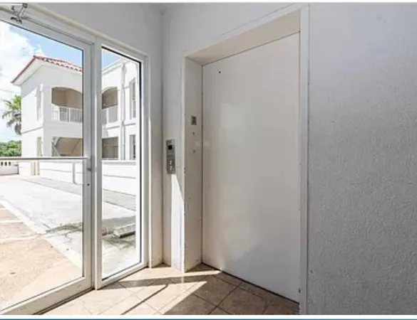 a view of a door and a window