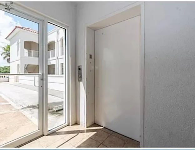 a view of a door and a window