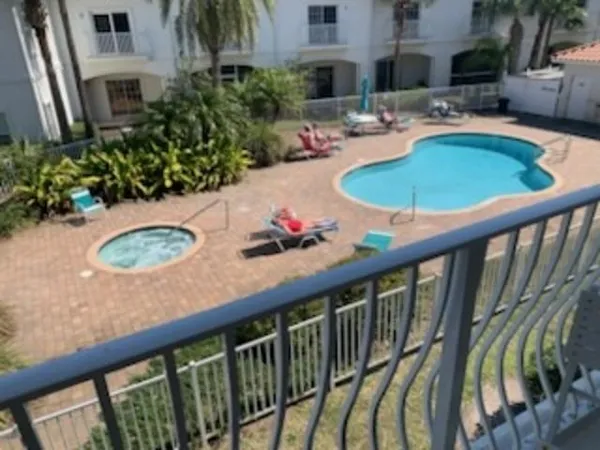 a view of balcony with furniture and garden